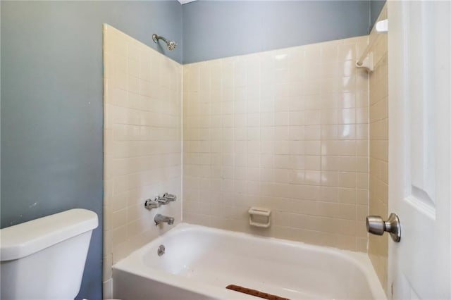 bathroom featuring tiled shower / bath and toilet