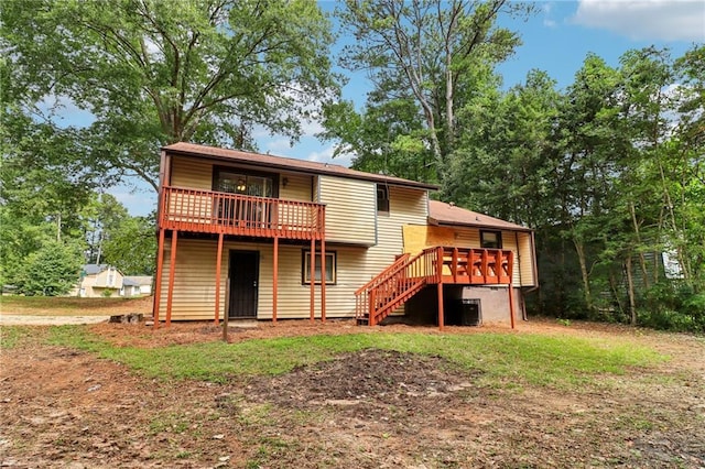 back of property with central air condition unit and a deck