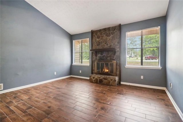 unfurnished living room with dark hardwood / wood-style flooring, a fireplace, and lofted ceiling