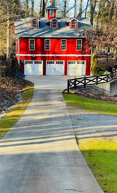 exterior space with a detached garage and fence