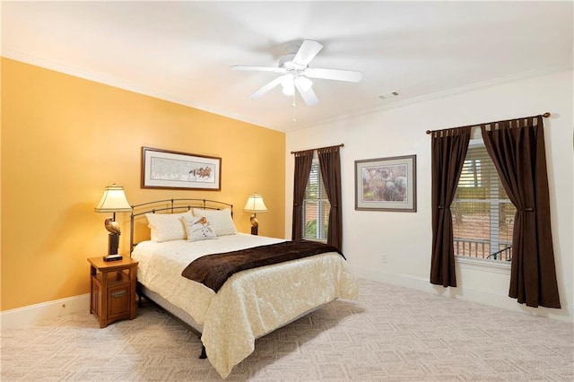 carpeted bedroom with ceiling fan and ornamental molding