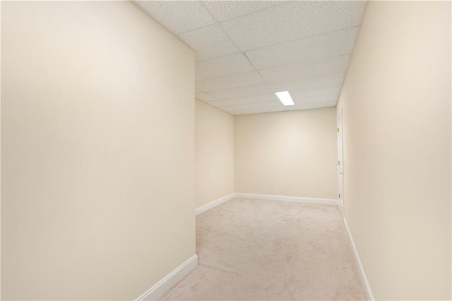 interior space featuring a drop ceiling and light carpet