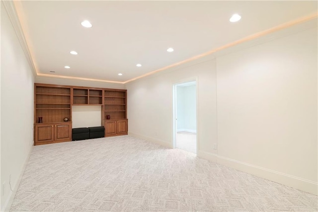 unfurnished living room featuring ornamental molding and light colored carpet