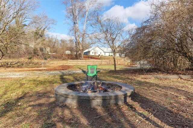 view of yard featuring fence and a fire pit