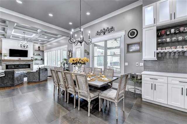 dining area with coffered ceiling, crown molding, a chandelier, and beam ceiling