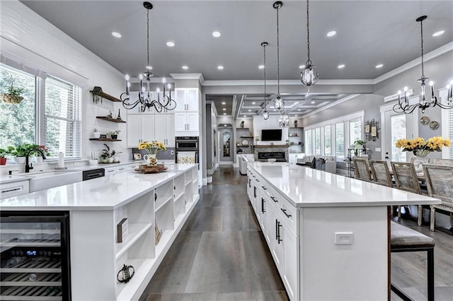 kitchen featuring sink, a chandelier, wine cooler, and a spacious island