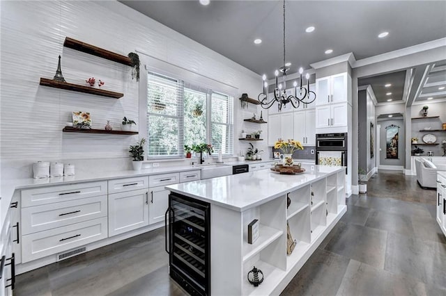 kitchen featuring white cabinetry, a kitchen island, hanging light fixtures, and wine cooler