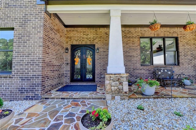 doorway to property with a porch and french doors