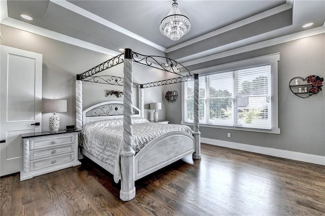 bedroom featuring a raised ceiling, crown molding, dark hardwood / wood-style flooring, and a notable chandelier