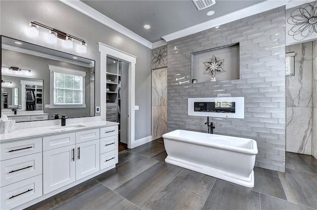 bathroom featuring a tub to relax in, vanity, and ornamental molding