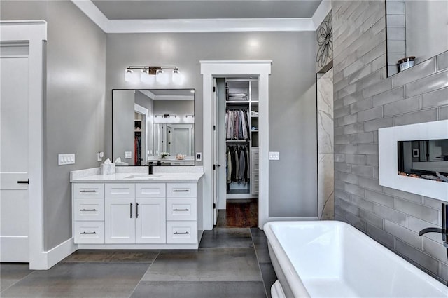 bathroom featuring crown molding, a tub to relax in, and vanity