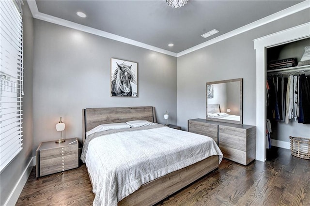 bedroom with a closet, crown molding, and dark hardwood / wood-style floors