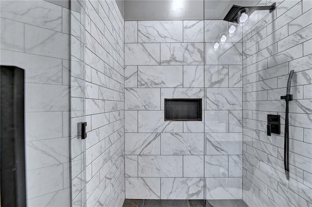 bathroom with a tile shower