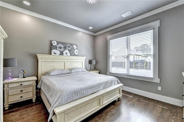 bedroom featuring crown molding and dark hardwood / wood-style floors