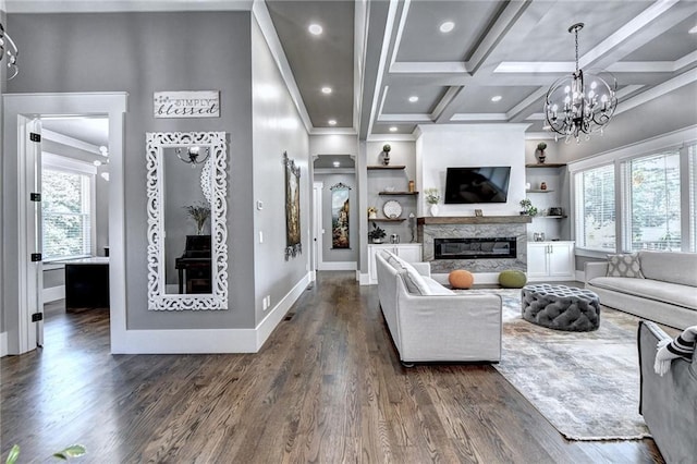 living room with dark hardwood / wood-style flooring, beamed ceiling, a chandelier, and coffered ceiling