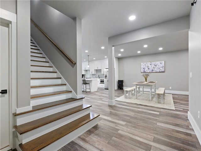 stairway featuring wood-type flooring