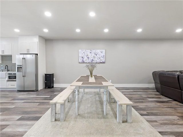 dining area featuring sink and wood-type flooring