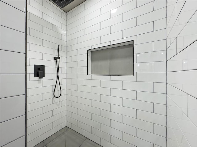 bathroom with a tile shower