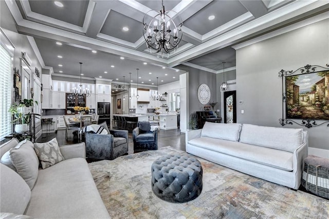 living room featuring ornamental molding, a chandelier, a high ceiling, and coffered ceiling