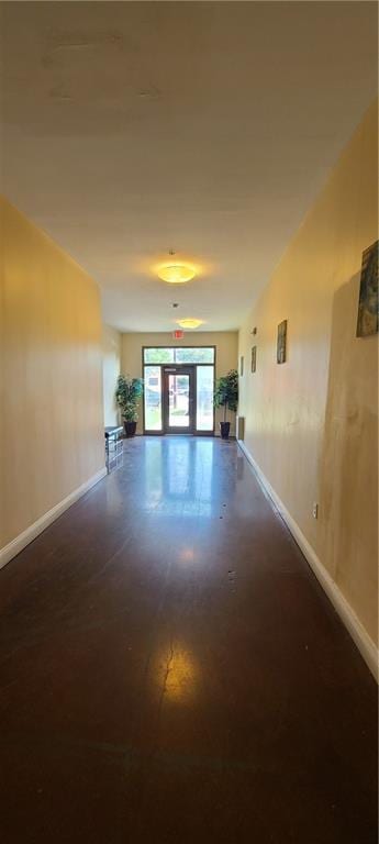 unfurnished living room featuring baseboards