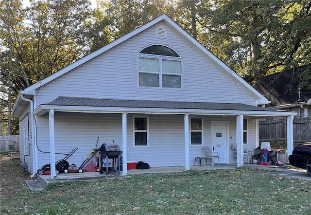 back of house with a lawn and a porch