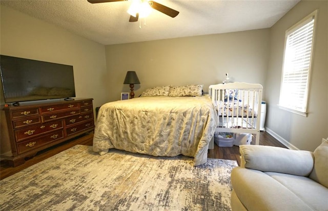 bedroom featuring wood-type flooring, a textured ceiling, and ceiling fan