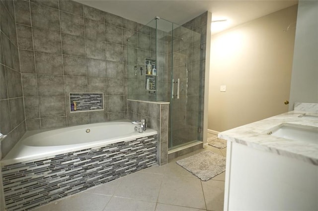 bathroom with shower with separate bathtub, vanity, and tile patterned floors