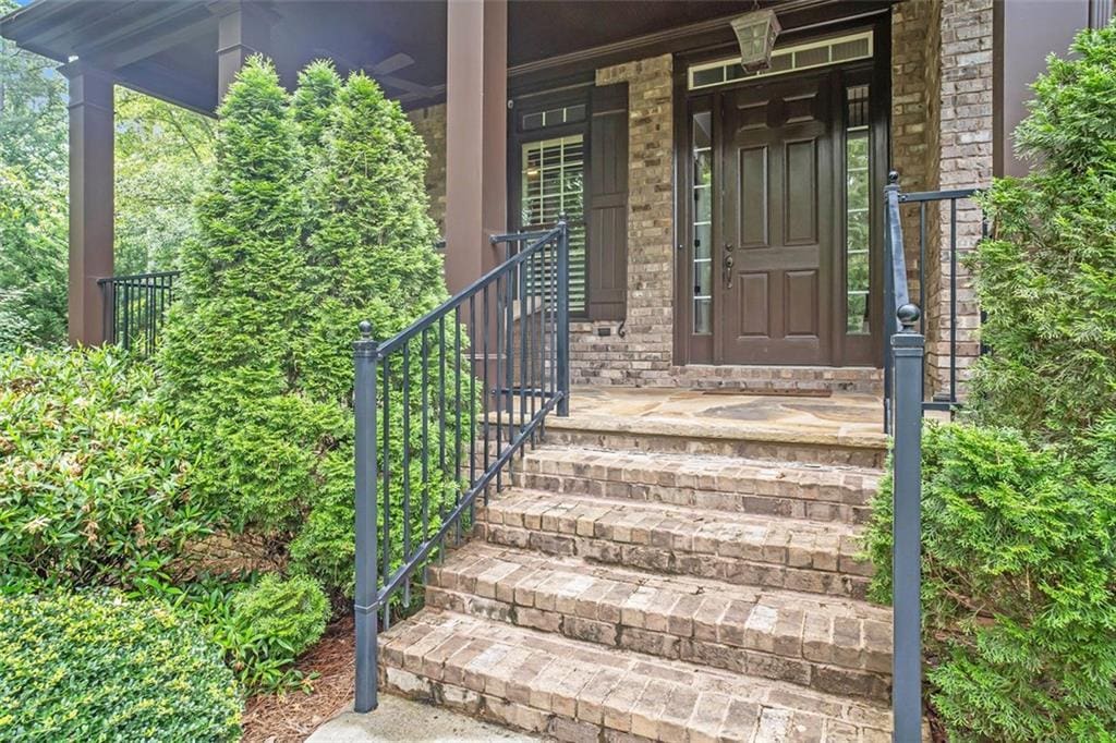 view of exterior entry featuring covered porch