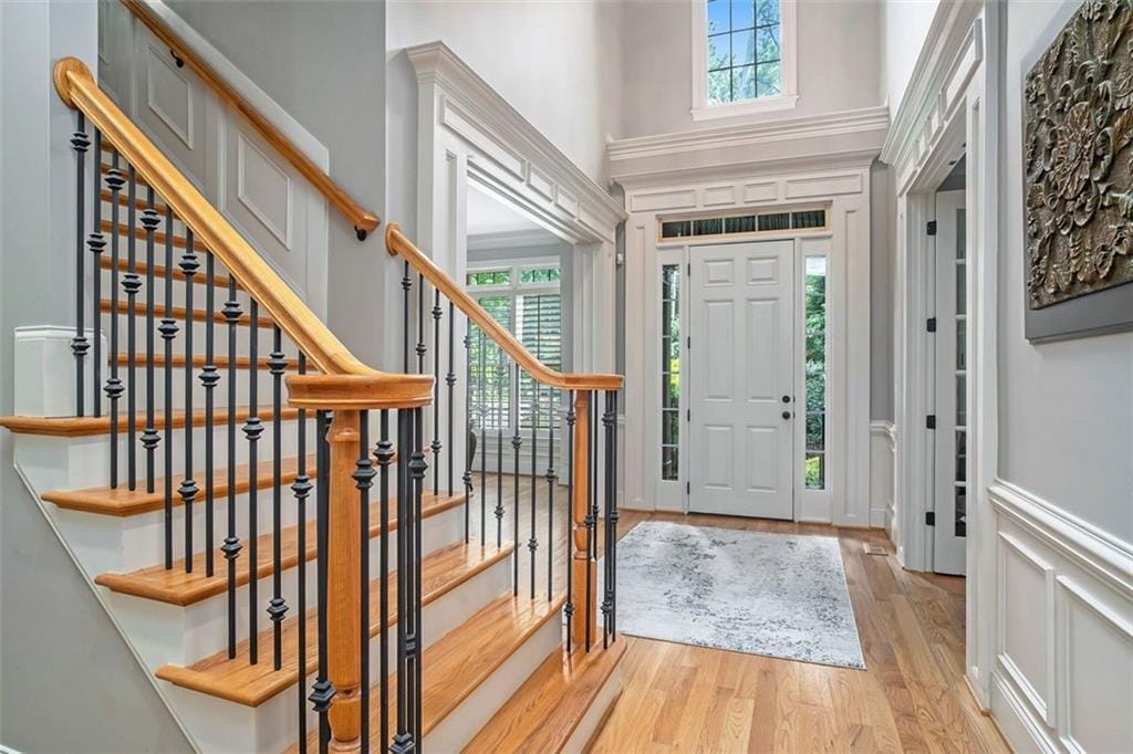 entrance foyer with light wood-type flooring and ornamental molding