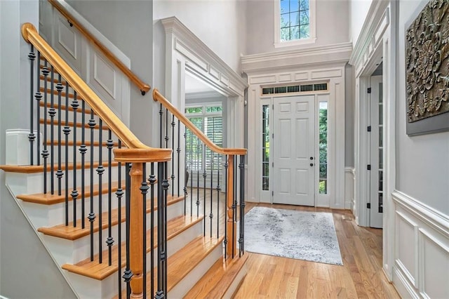 entrance foyer with light wood-type flooring and ornamental molding