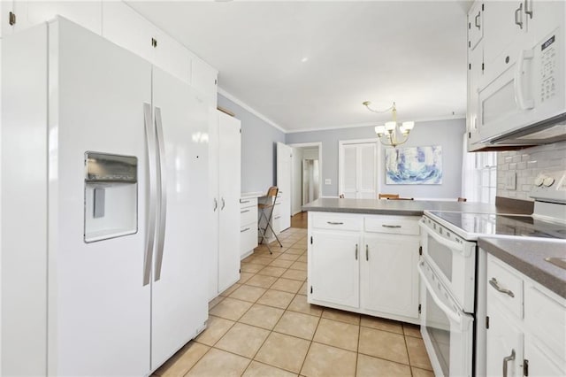 kitchen featuring dark countertops, backsplash, light tile patterned flooring, white appliances, and a peninsula