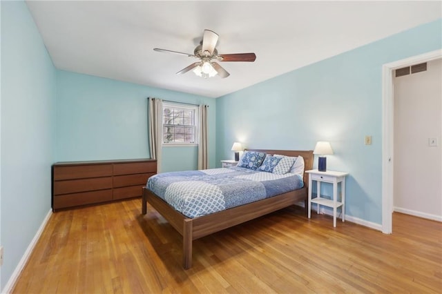 bedroom with light wood-style floors, baseboards, and visible vents