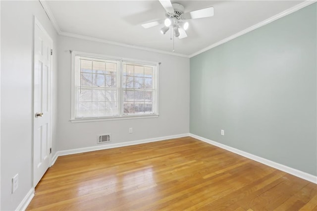 interior space featuring baseboards, ornamental molding, visible vents, and light wood-style floors