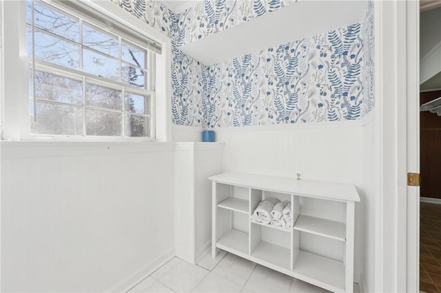 bathroom with a wainscoted wall and tile patterned floors