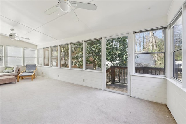 unfurnished sunroom featuring vaulted ceiling and a ceiling fan