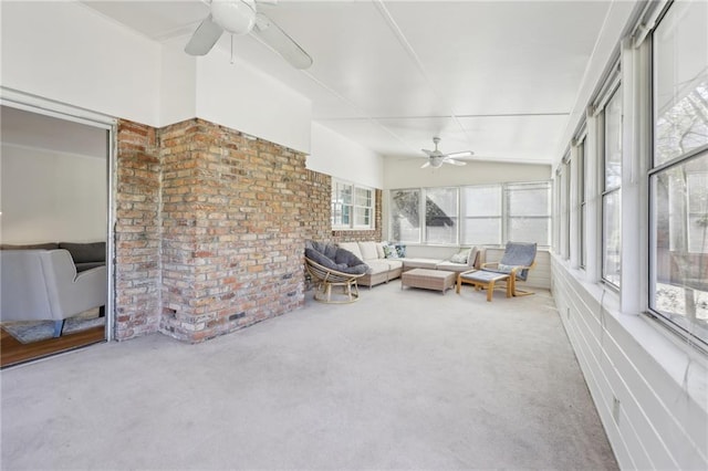 unfurnished sunroom featuring ceiling fan and vaulted ceiling