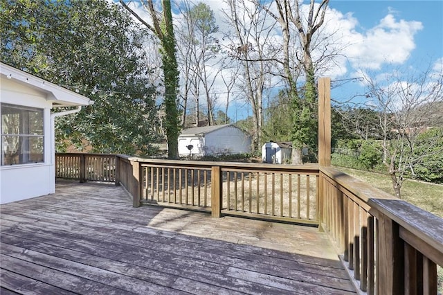 deck with a shed and an outbuilding