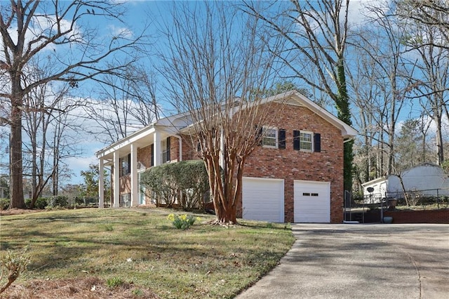 view of front facade with a front lawn, concrete driveway, brick siding, and an attached garage