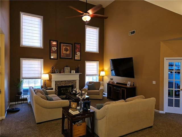 living room featuring ceiling fan, high vaulted ceiling, dark carpet, and a wealth of natural light