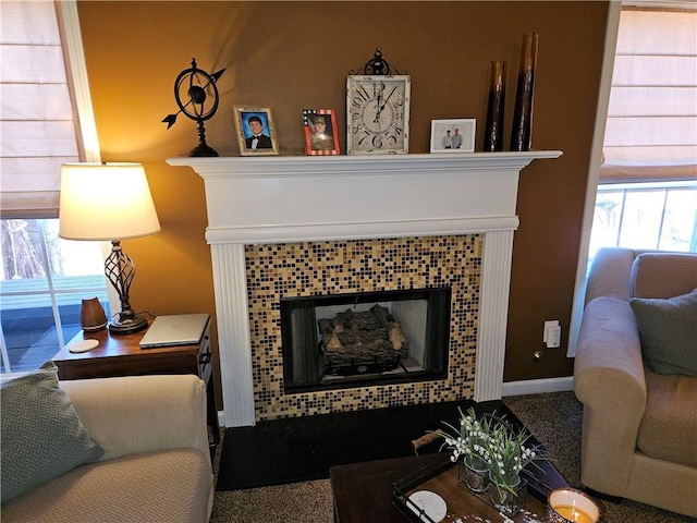 living room with a tiled fireplace