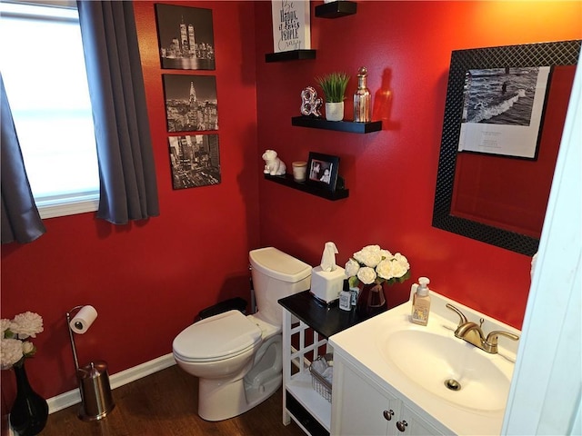 bathroom with vanity, toilet, and wood-type flooring