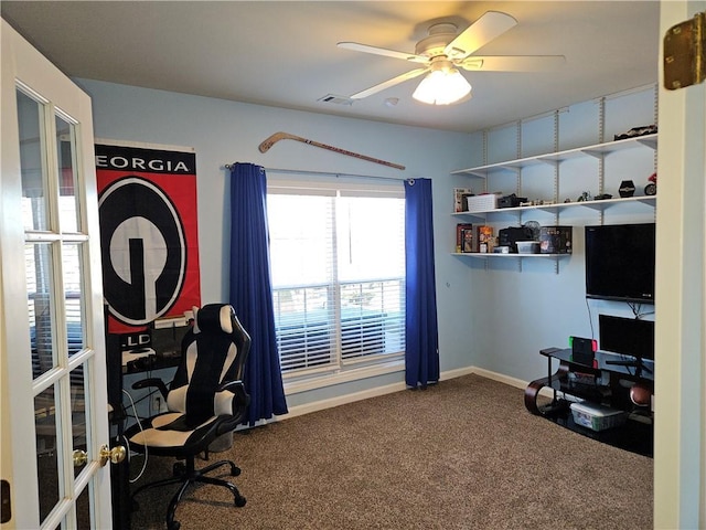 carpeted office space with french doors and ceiling fan