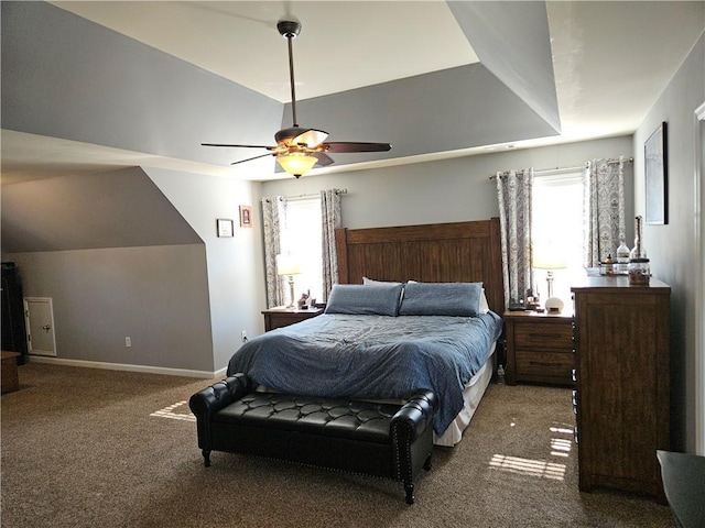 carpeted bedroom featuring multiple windows, vaulted ceiling, and ceiling fan