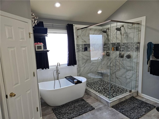 bathroom with lofted ceiling, wood-type flooring, and independent shower and bath