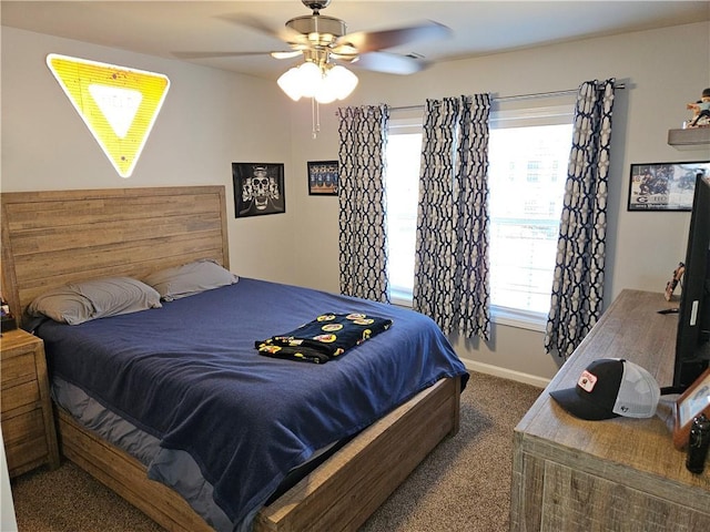 carpeted bedroom featuring multiple windows and ceiling fan