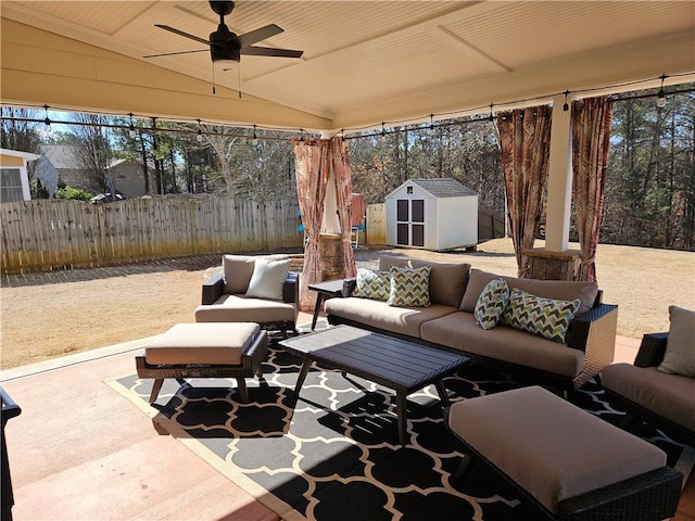 view of patio with outdoor lounge area, ceiling fan, and a shed