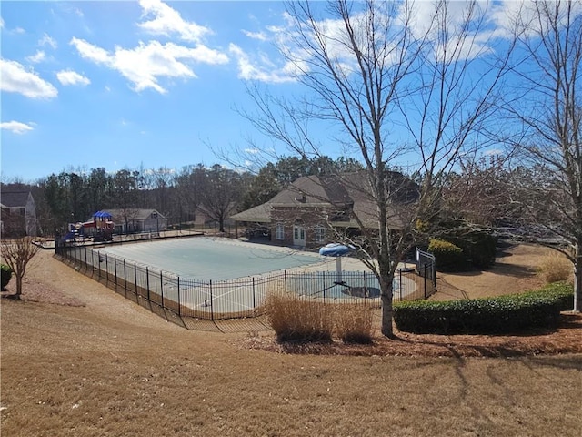 view of pool featuring a yard