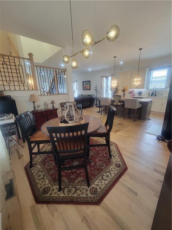 dining area featuring light wood-type flooring and sink