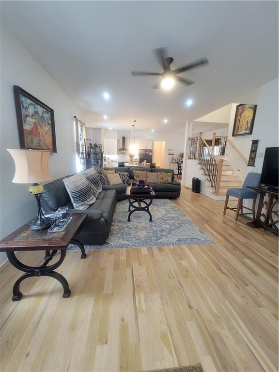 living room with ceiling fan and light wood-type flooring