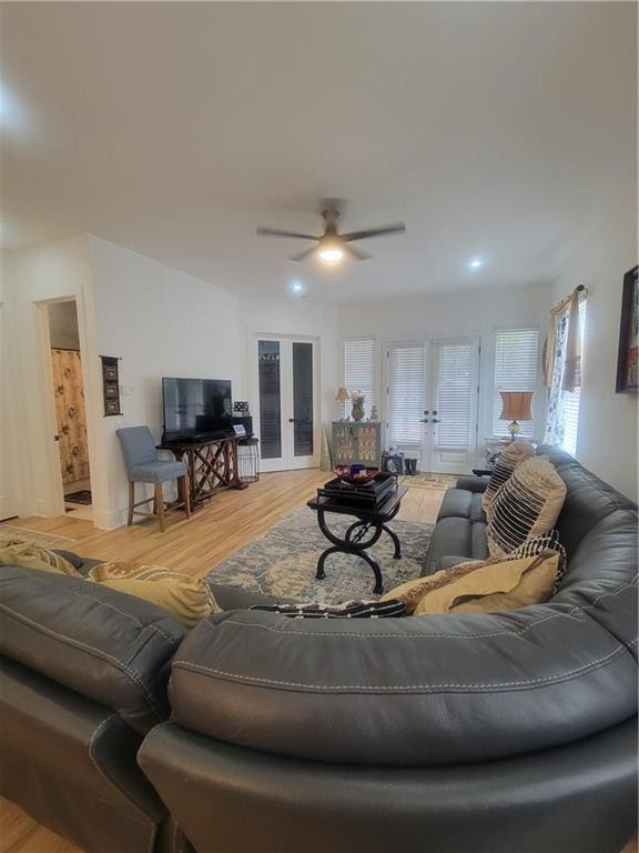 living room with french doors, light hardwood / wood-style floors, and ceiling fan